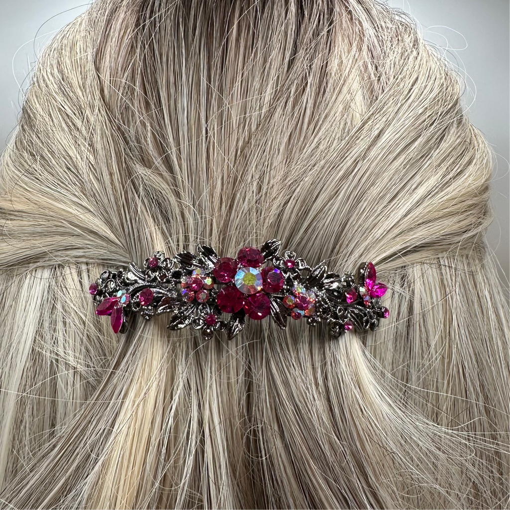 Fuchsia hair accessory barrette in a half up half down hairstyle