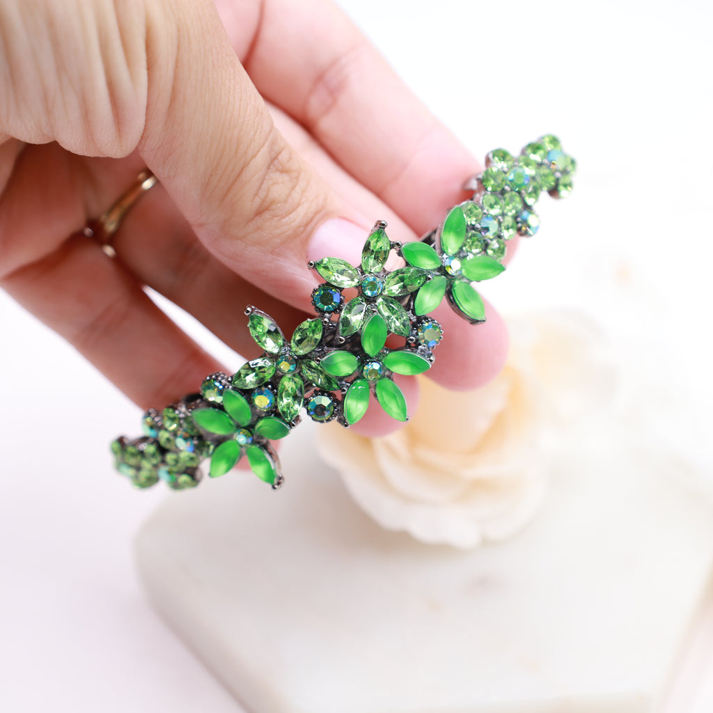 Luxurious curved hair clip with navy blue floral crystals, ideal for bridal, prom, or evening hairstyles.