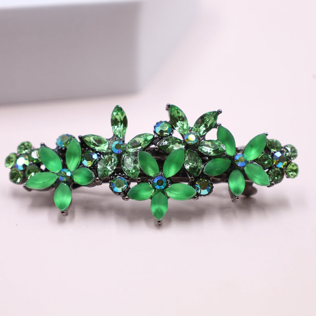Vibrant green hair barrette with shimmering crystals, adding a pop of color to a sleek updo