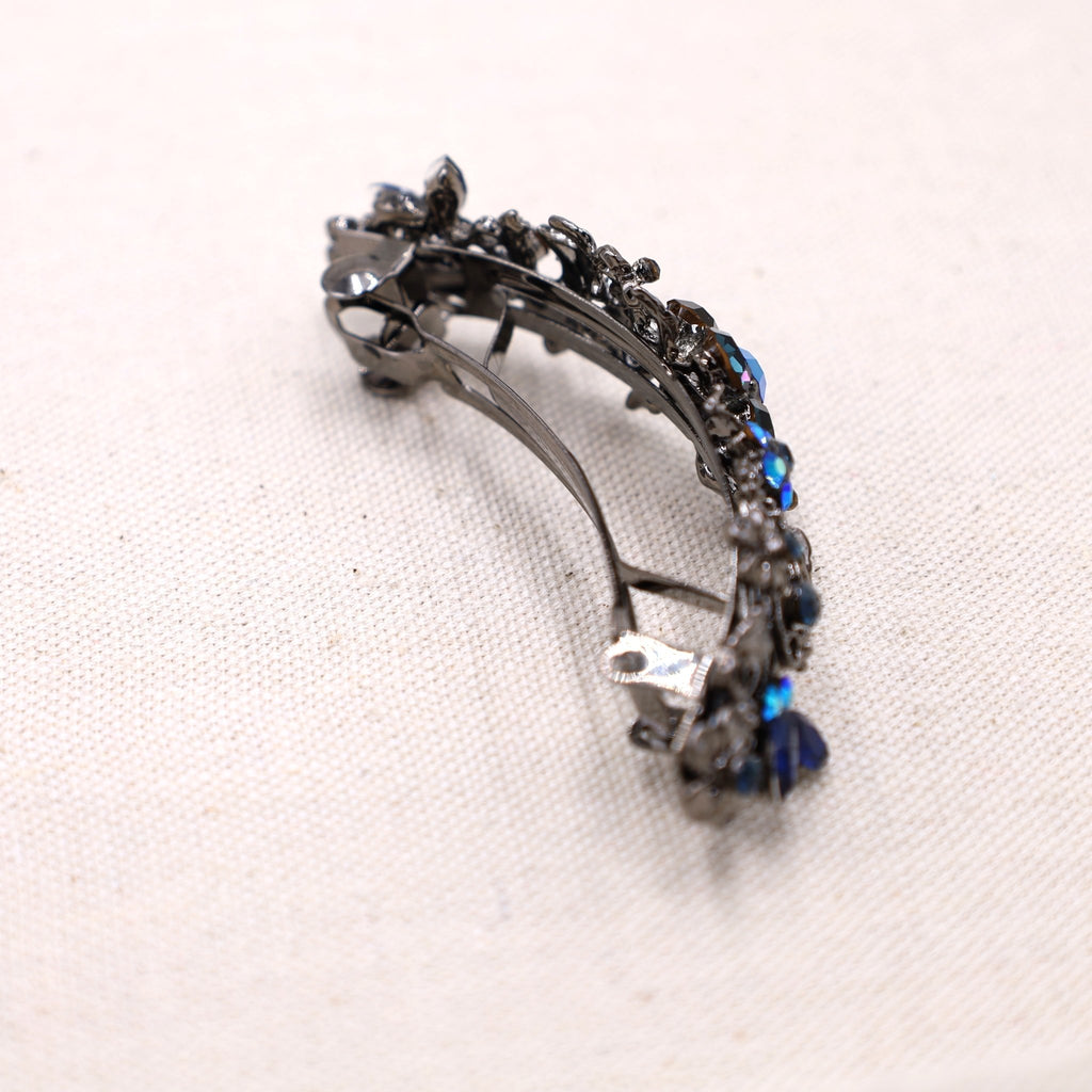 side view of a hair barrette to hold your thick hair in place with navy blue crystals