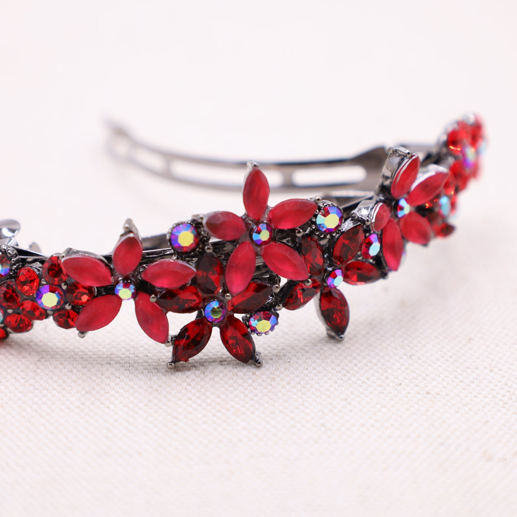 Elegant red crystal hair barrette beautifully adorning thick, luxurious strands.