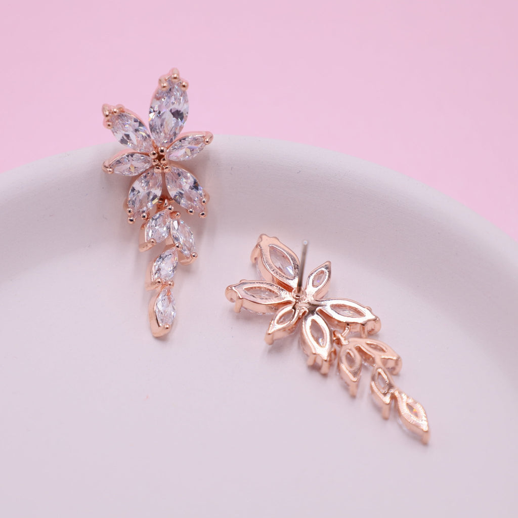 Radiant rose gold earrings featuring sparkling clear crystals, perfect for adding sophistication to weddings
