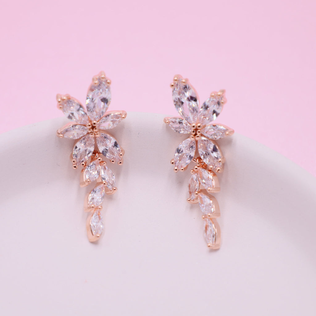 Elegant rose gold wedding earrings adorned with clear crystals, a timeless addition to bridal elegance.