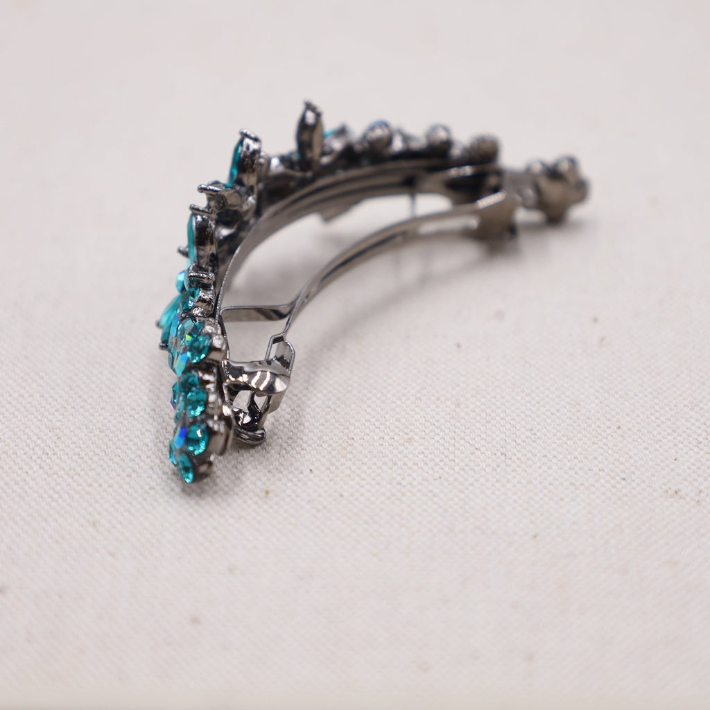 A fashion-forward hair accessory featuring a teal hue, tailored for long and thick strands.