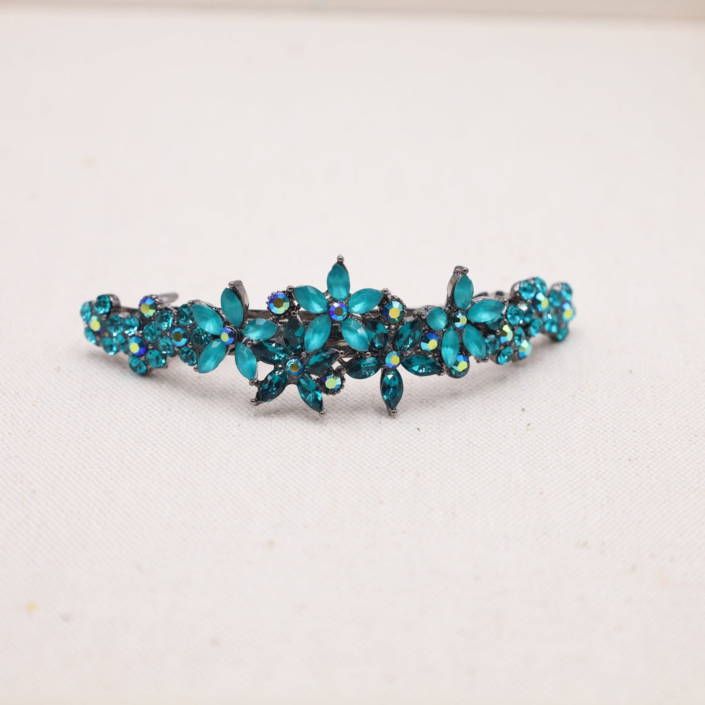 A trendy teal hair clip, ideal for adding a pop of color to your gorgeous, flowing mane.