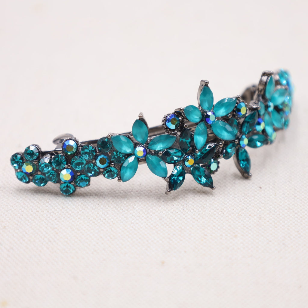 Stunning hair barrette in a mesmerizing shade of turquoise for luxurious, voluminous hair.