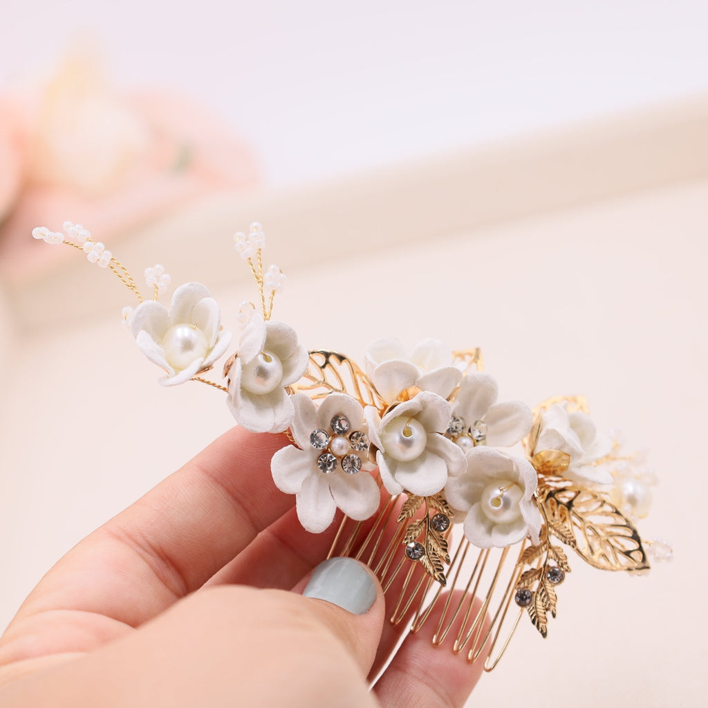 wedding hair comb with white flower and pearls in a gold metal comb